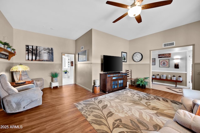 living room with wood-type flooring and ceiling fan