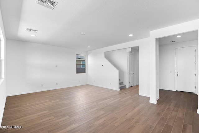 basement with stairs, visible vents, wood finished floors, and recessed lighting