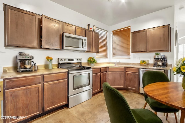 kitchen featuring light tile patterned floors and appliances with stainless steel finishes