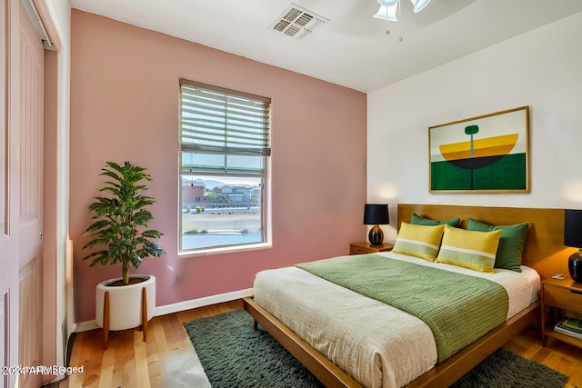 bedroom featuring a closet, hardwood / wood-style flooring, and ceiling fan