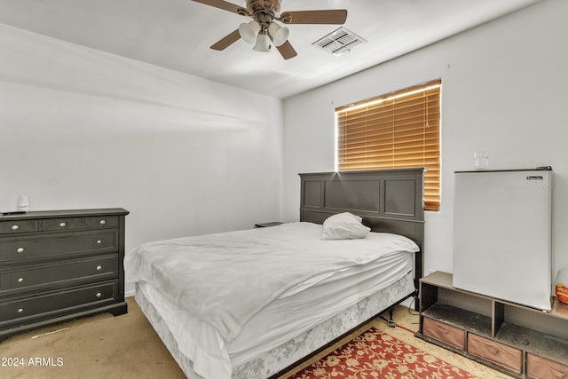 bedroom with ceiling fan and light carpet