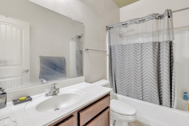 full bathroom with vanity, shower / bath combo, and toilet