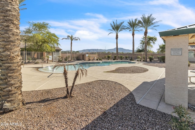 view of pool with a mountain view and a patio