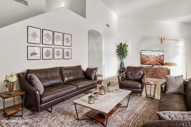 living room featuring high vaulted ceiling