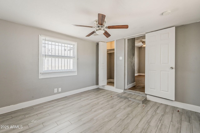 unfurnished bedroom with light wood-style flooring, baseboards, and a ceiling fan