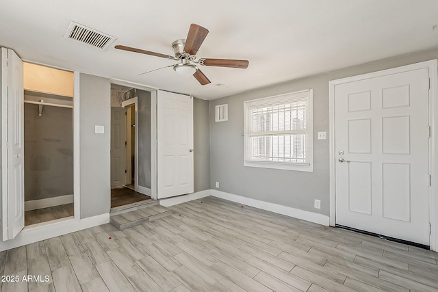 unfurnished bedroom featuring baseboards, light wood finished floors, and ceiling fan