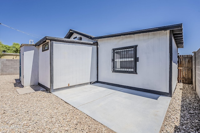 back of house featuring a fenced backyard and a patio