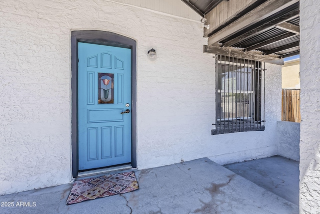 property entrance featuring stucco siding