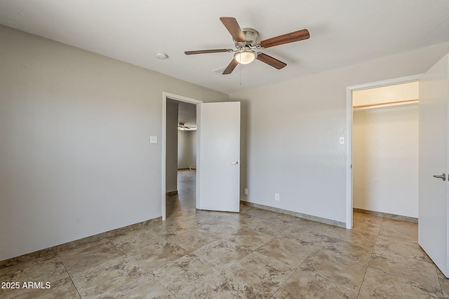 unfurnished bedroom featuring ceiling fan and baseboards