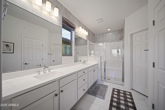 bathroom featuring vanity and a shower with door