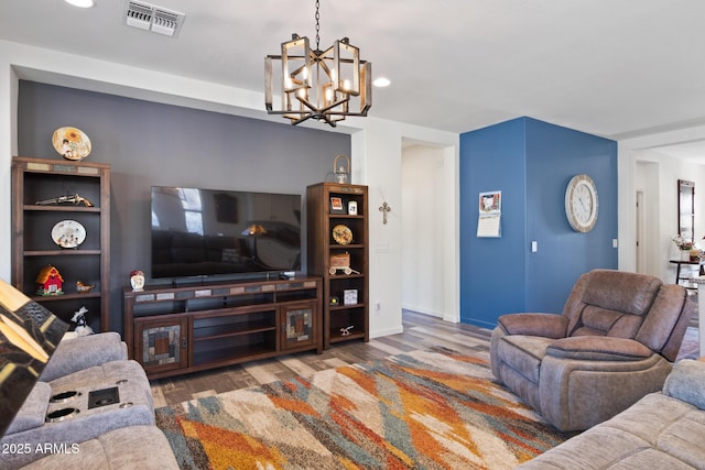 living room featuring hardwood / wood-style floors and an inviting chandelier