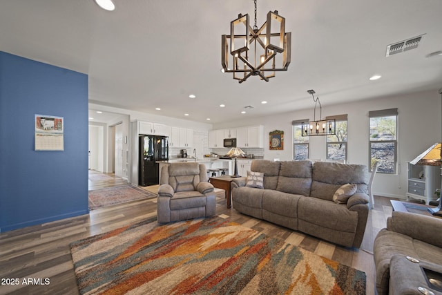 living room with a chandelier and hardwood / wood-style floors