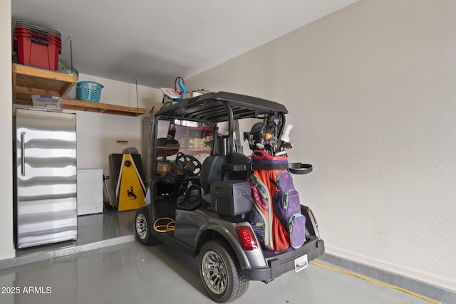 garage with stainless steel fridge