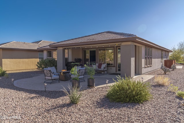 rear view of property featuring a patio area