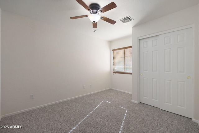 unfurnished bedroom featuring ceiling fan, carpet flooring, and a closet