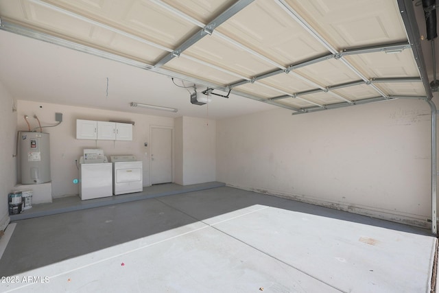 garage featuring a garage door opener, washer and clothes dryer, and water heater