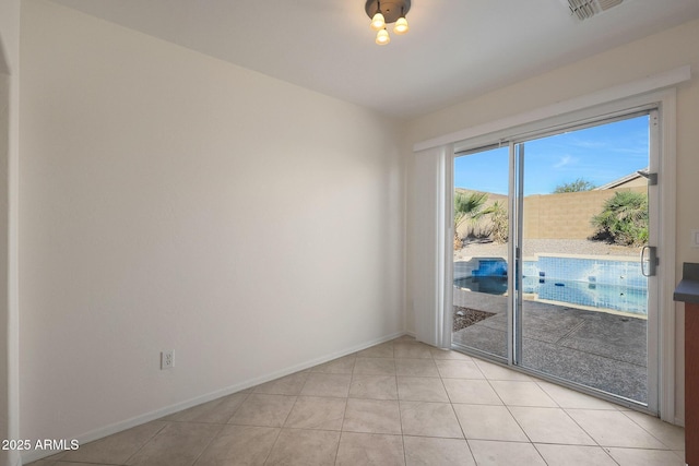 spare room featuring light tile patterned floors