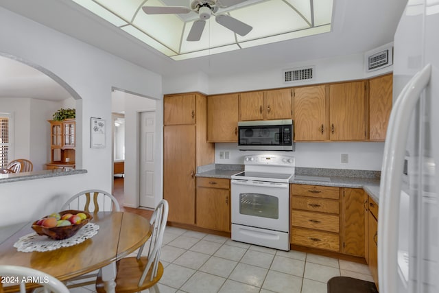 kitchen with ceiling fan, light tile patterned floors, and white appliances