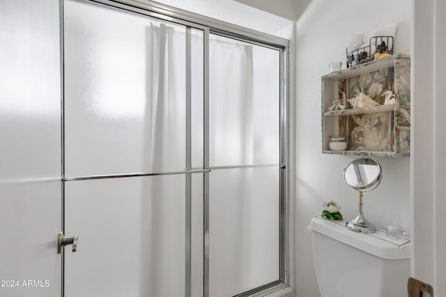 bathroom featuring a shower and toilet