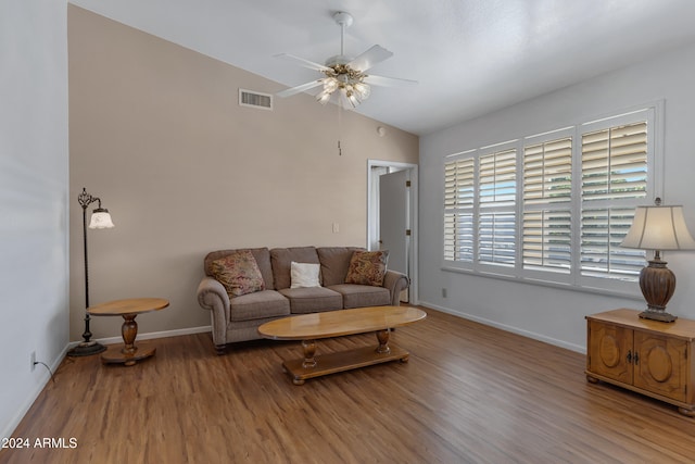 living room with hardwood / wood-style flooring, ceiling fan, and lofted ceiling