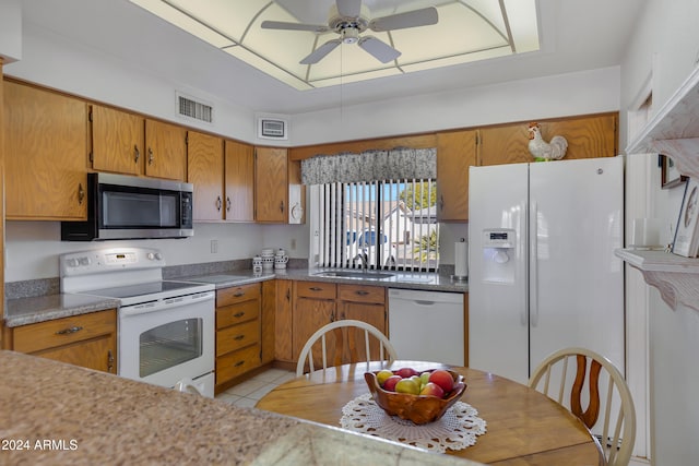 kitchen featuring ceiling fan, white appliances, sink, and light tile patterned floors