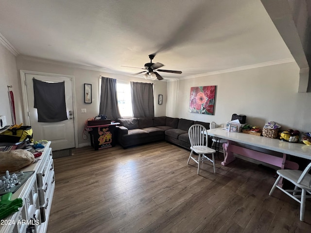 living room with ornamental molding, dark hardwood / wood-style flooring, and ceiling fan