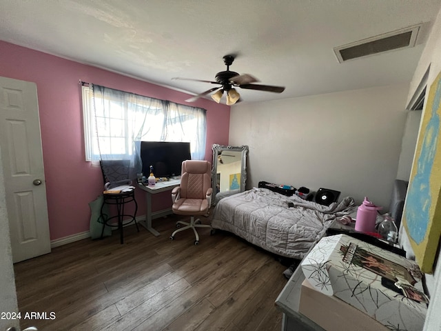 bedroom with ceiling fan and dark wood-type flooring