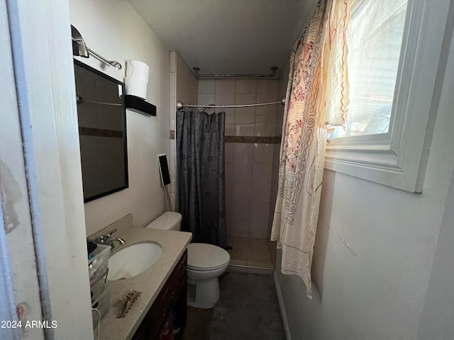 bathroom featuring toilet, vanity, and a shower with shower curtain