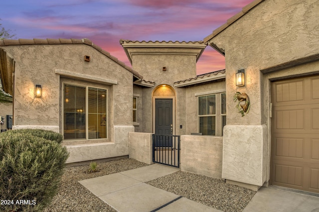 15201 S 183rd Dr, Goodyear, AZ 85338 - doorway to property featuring an attached garage, a gate, and a tiled roof