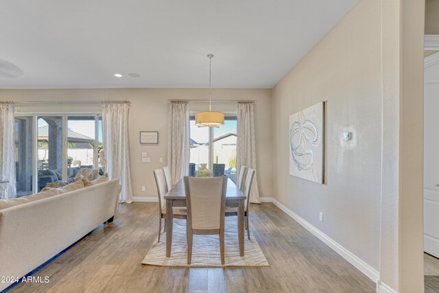 dining space featuring light wood-type flooring