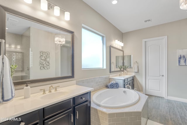15201 S 183rd Dr, Goodyear, AZ 85338 - full bathroom featuring an enclosed shower, a sink, two vanities, a bath, and visible vents