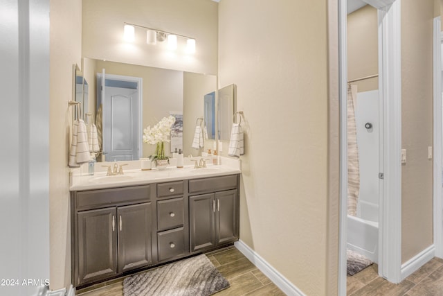 15201 S 183rd Dr, Goodyear, AZ 85338 - full bath with baseboards, double vanity, a sink, and wood finish floors