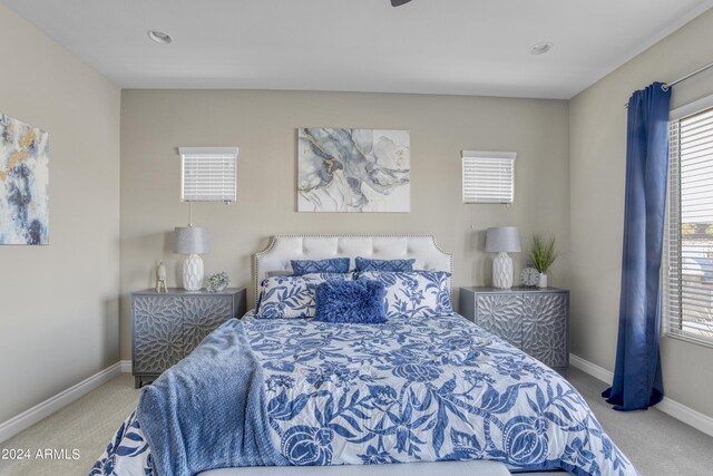 bedroom with ceiling fan and light colored carpet