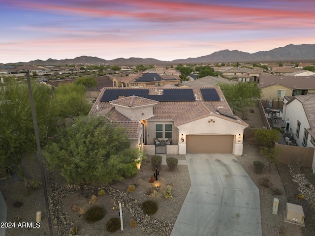 15201 S 183rd Dr, Goodyear, AZ 85338 - view of front of house featuring a tiled roof, an attached garage, stucco siding, driveway, and a mountain view