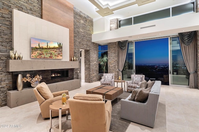 living room featuring a large fireplace and a high ceiling