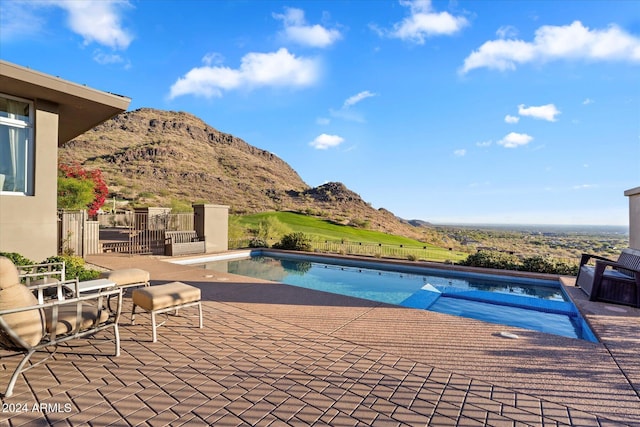 view of pool featuring a patio area and a mountain view