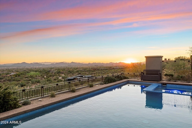 pool at dusk with a mountain view