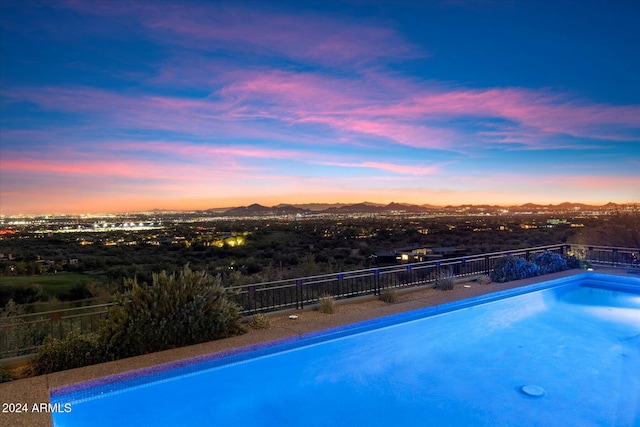 pool at dusk with a mountain view