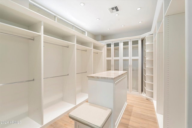 walk in closet featuring light hardwood / wood-style floors