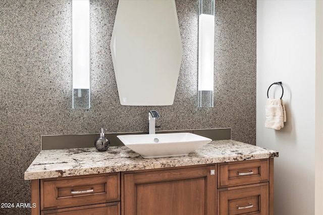 bathroom featuring vanity and tasteful backsplash