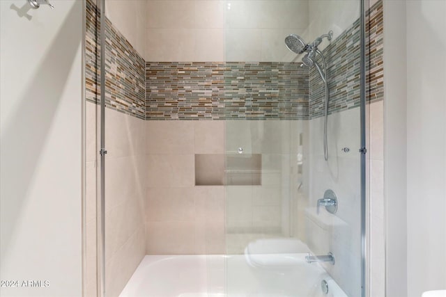 bathroom with shower / bath combination with glass door