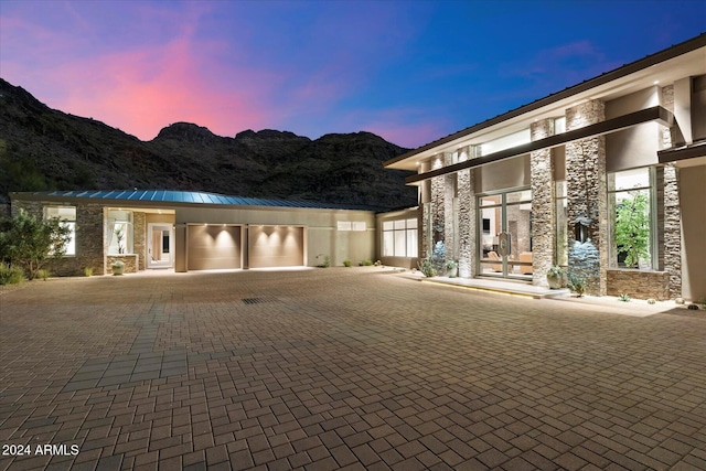 view of front of home with a mountain view and a garage