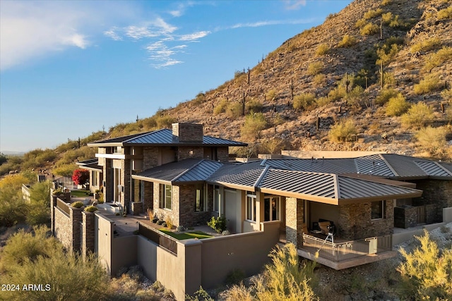 rear view of property featuring a mountain view