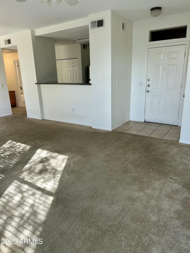 unfurnished living room with light colored carpet