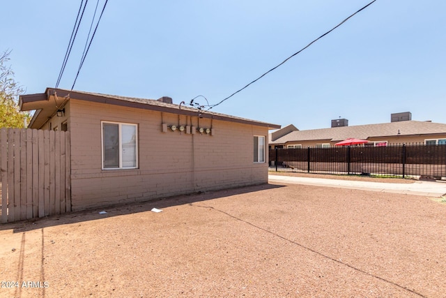 view of property exterior with a patio area