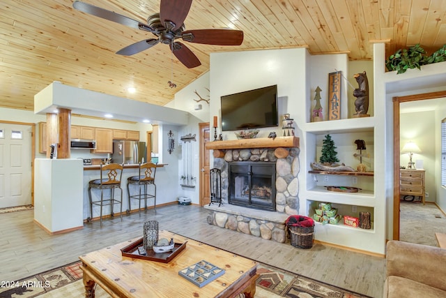 living room featuring wood ceiling, built in shelves, a fireplace, and light wood-style flooring