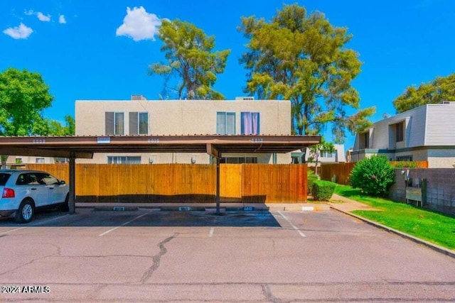 5906 W Townley Ave, Glendale, AZ 85302 - view of front of house featuring covered parking, fence, and stucco siding