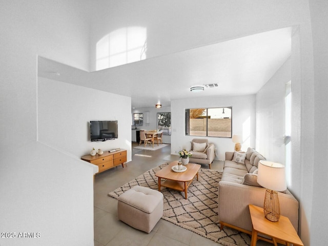 tiled living room with a high ceiling