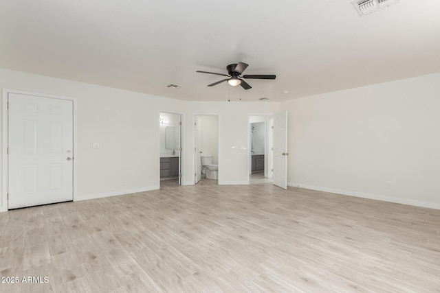 unfurnished bedroom featuring baseboards, visible vents, connected bathroom, and light wood finished floors