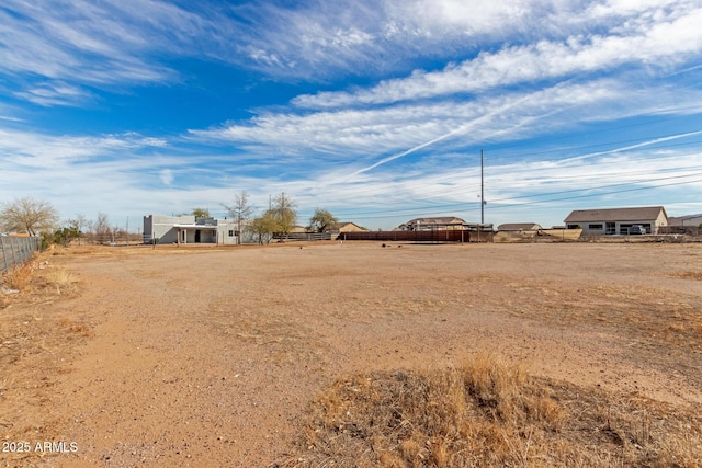 view of yard featuring fence and a rural view